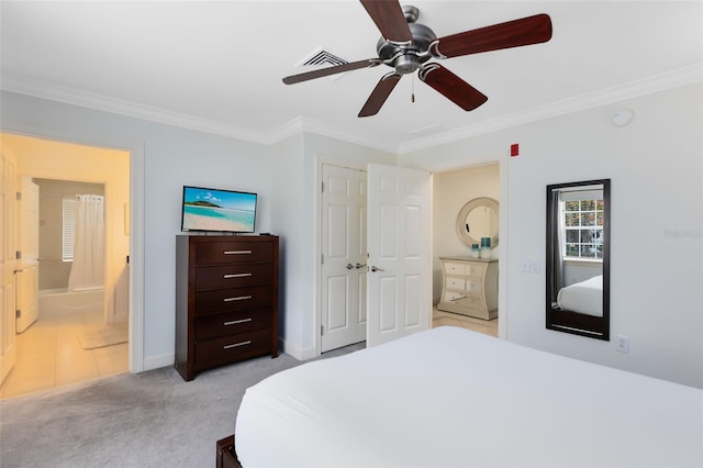 bedroom with ceiling fan, connected bathroom, light colored carpet, and crown molding