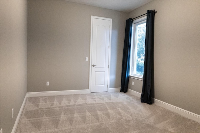 unfurnished room with light carpet