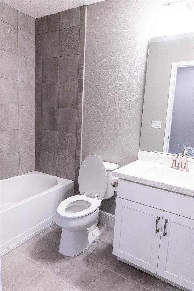 full bathroom featuring toilet, vanity,  shower combination, and tile patterned flooring