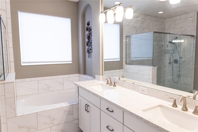 bathroom featuring vanity, a wealth of natural light, and shower with separate bathtub