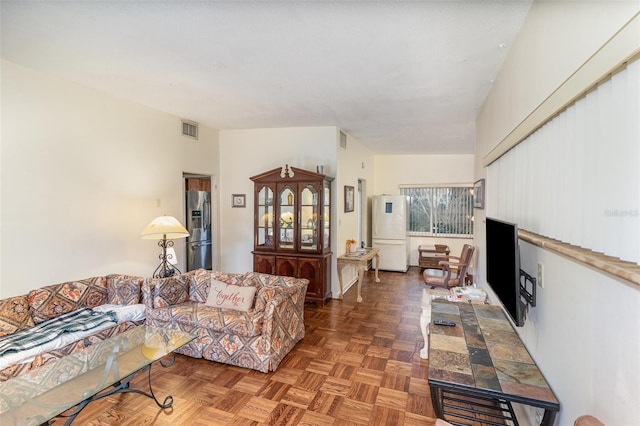 living room featuring dark parquet floors