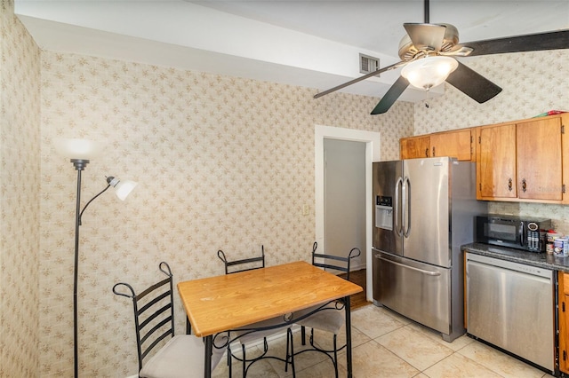 kitchen featuring appliances with stainless steel finishes, ceiling fan, and light tile patterned floors