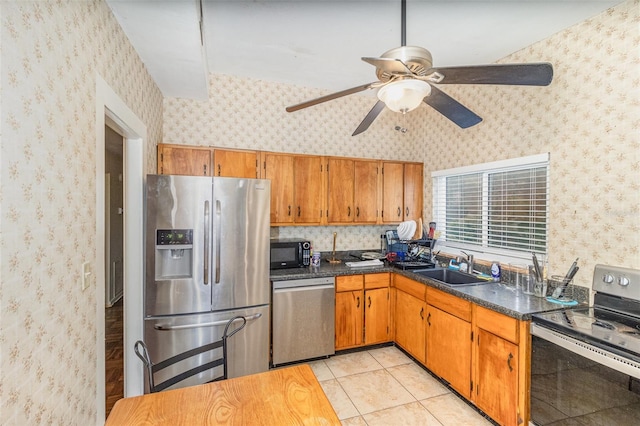 kitchen with appliances with stainless steel finishes, ceiling fan, sink, and light tile patterned floors