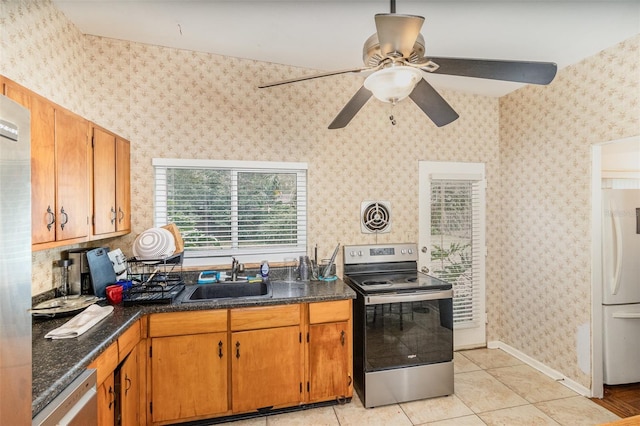 kitchen featuring appliances with stainless steel finishes, ceiling fan, light tile patterned flooring, and sink