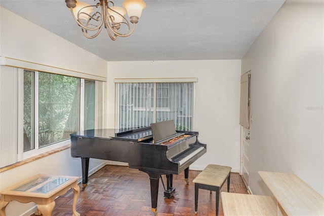 misc room featuring an inviting chandelier and dark parquet floors