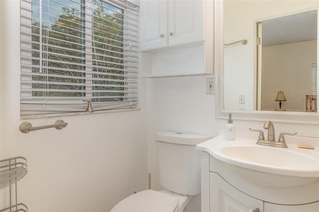 bathroom featuring toilet and vanity