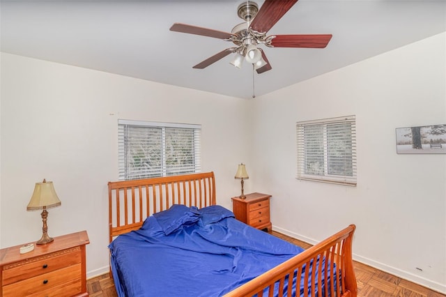 bedroom featuring ceiling fan and parquet floors