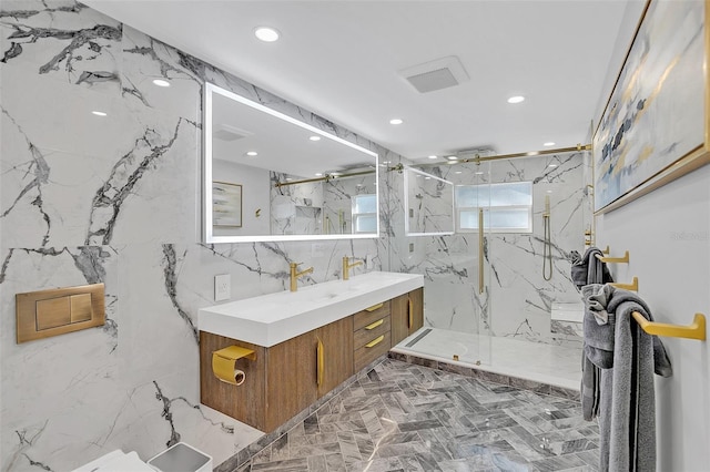 bathroom featuring tile walls, a tile shower, and vanity