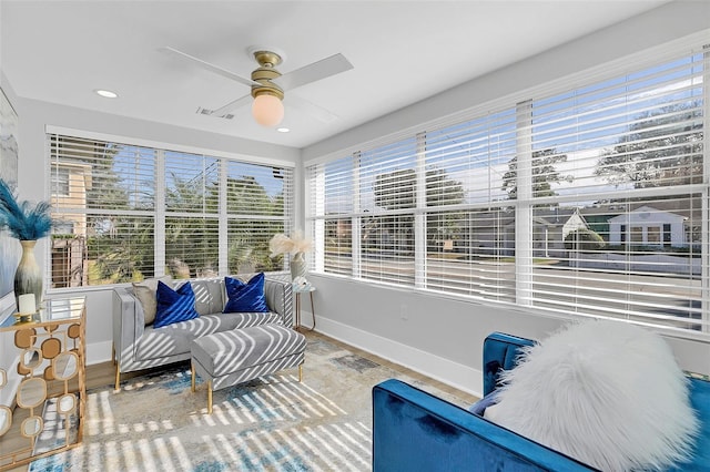 sunroom featuring ceiling fan