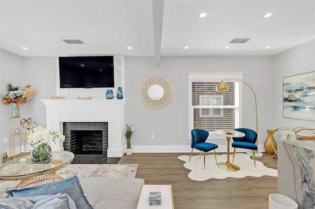 living room with dark hardwood / wood-style floors and a fireplace