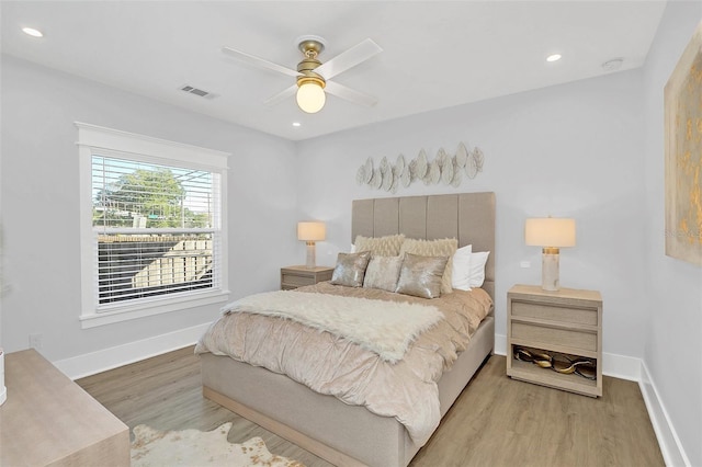 bedroom with light wood-type flooring and ceiling fan