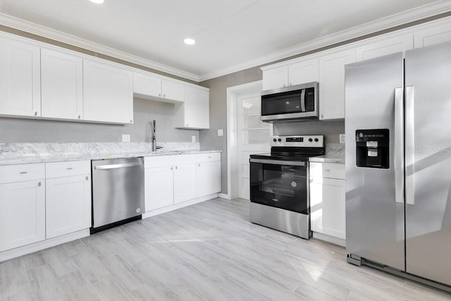 kitchen featuring white cabinetry, sink, and appliances with stainless steel finishes