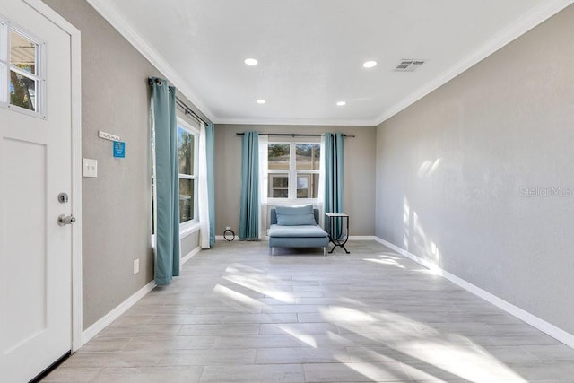 unfurnished room with light hardwood / wood-style flooring and crown molding