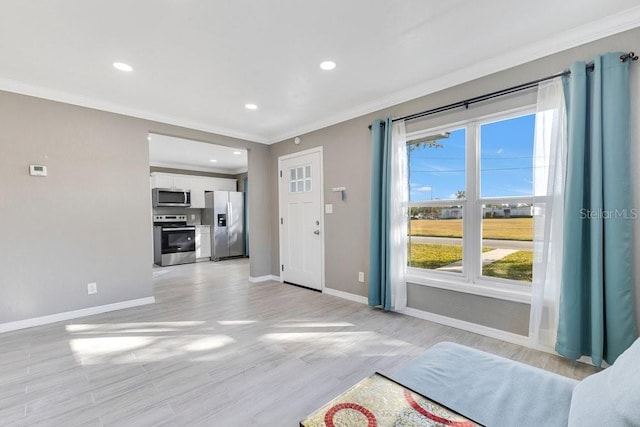 unfurnished living room with crown molding and light hardwood / wood-style flooring