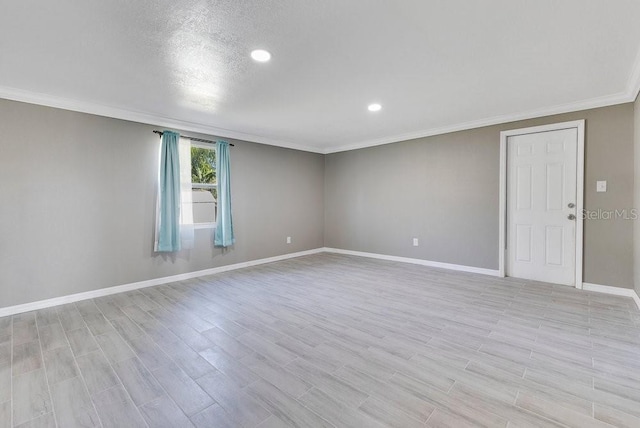 empty room with light hardwood / wood-style floors and ornamental molding