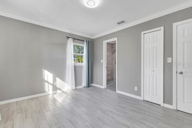 unfurnished bedroom featuring light hardwood / wood-style flooring and crown molding