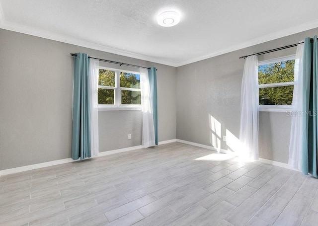 unfurnished room with a textured ceiling, light hardwood / wood-style flooring, and ornamental molding