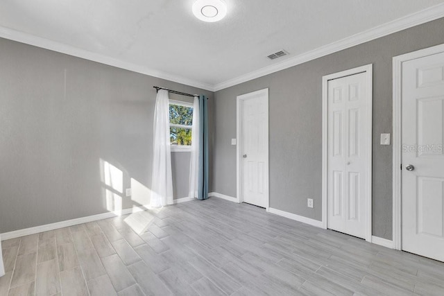 unfurnished bedroom featuring crown molding