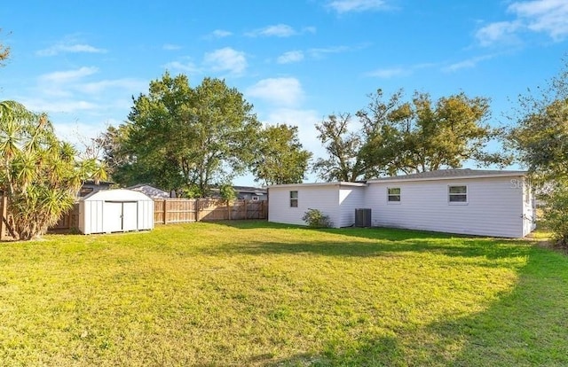 view of yard featuring a storage unit and central air condition unit