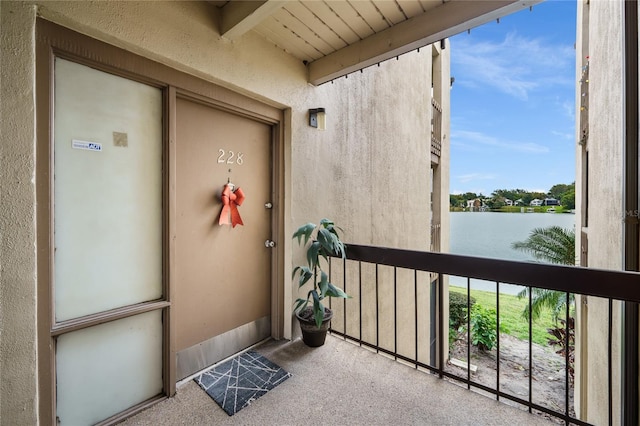 exterior space with a water view and a balcony