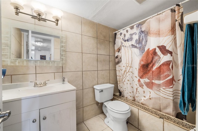 full bathroom featuring tasteful backsplash, a textured ceiling, toilet, vanity, and tile walls