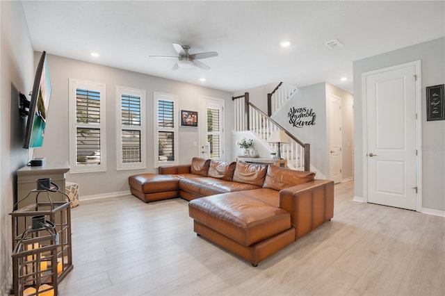 living room with ceiling fan and light wood-type flooring