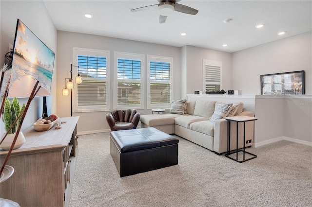 living room featuring light colored carpet and ceiling fan