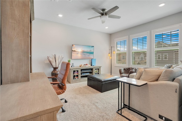 carpeted living room featuring ceiling fan