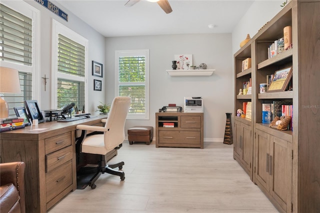 home office with ceiling fan and light hardwood / wood-style floors