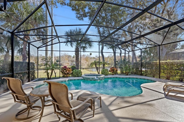 view of pool featuring a lanai, a patio area, and an in ground hot tub