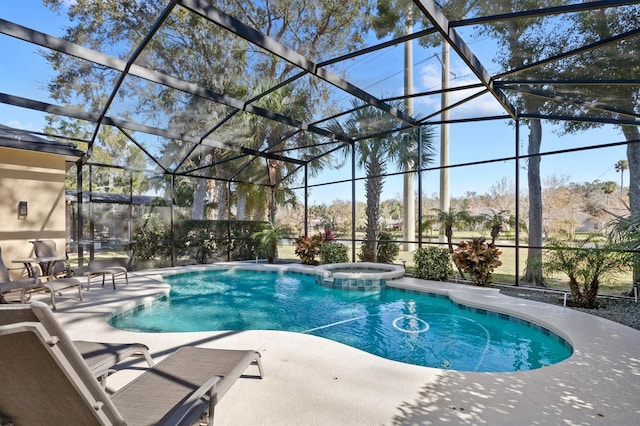 view of swimming pool featuring an in ground hot tub, a patio, and a lanai