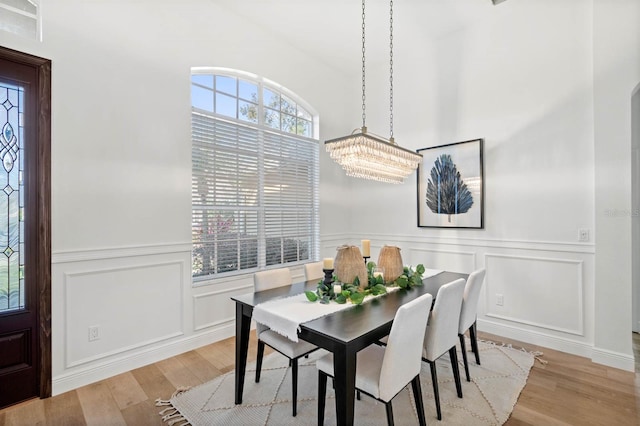 dining space featuring a notable chandelier and light wood-type flooring