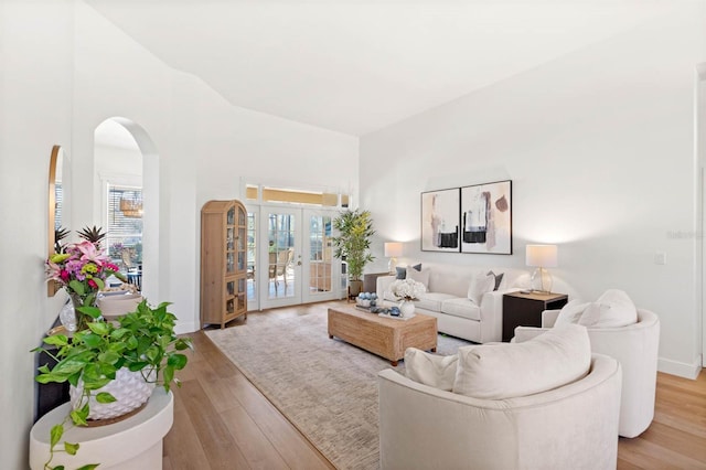 living room featuring light wood-type flooring and french doors