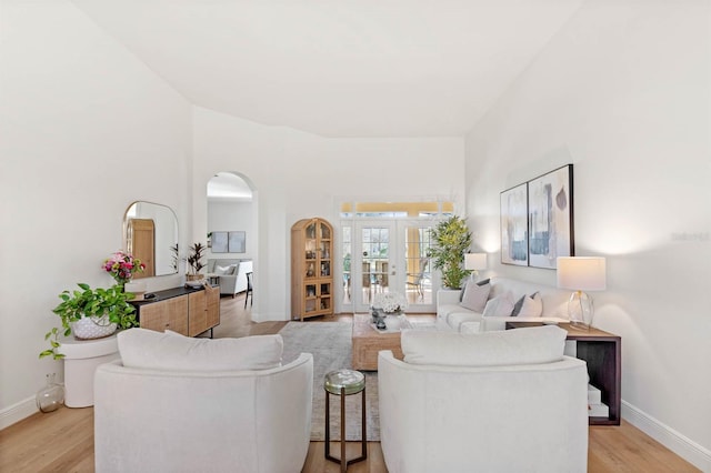 living room with french doors and light wood-type flooring