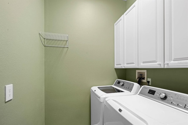 washroom with cabinets and separate washer and dryer