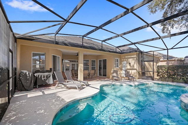 back of house with a patio, glass enclosure, and ceiling fan