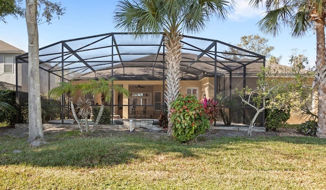 view of yard featuring ceiling fan and a lanai