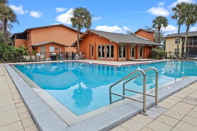 view of pool with a patio area and grilling area