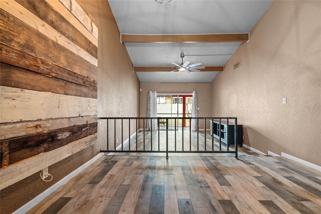 hall with wood-type flooring and lofted ceiling with beams