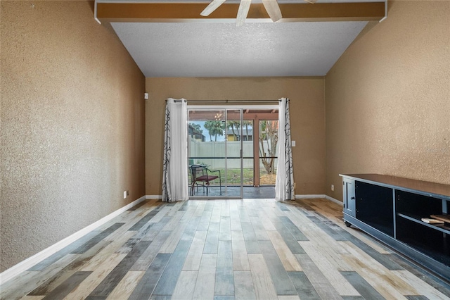 unfurnished room with hardwood / wood-style floors and a textured ceiling