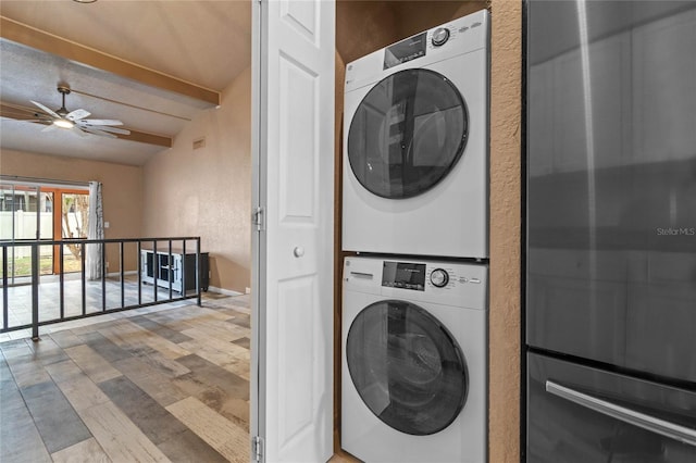 laundry room featuring stacked washer / drying machine, ceiling fan, and hardwood / wood-style flooring