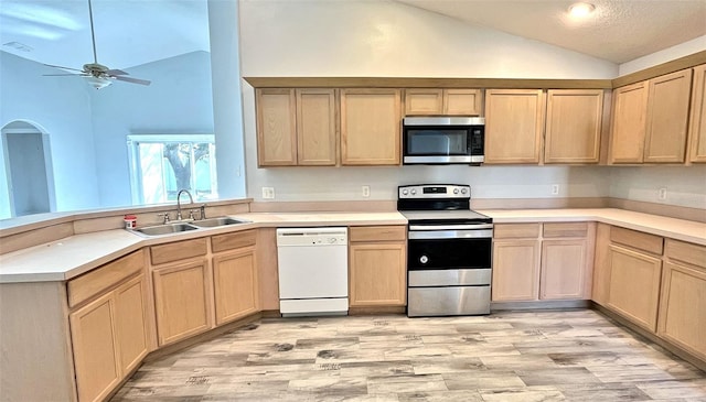 kitchen with ceiling fan, light brown cabinets, sink, lofted ceiling, and appliances with stainless steel finishes