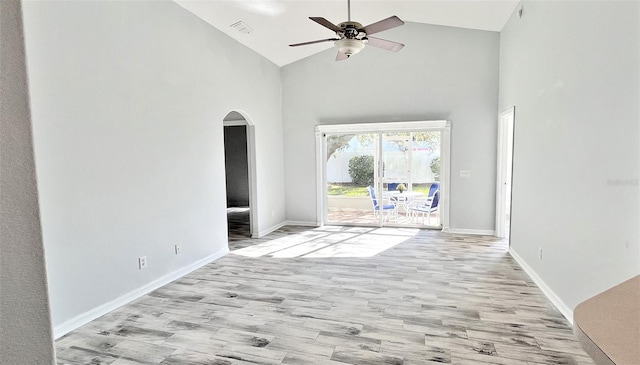 unfurnished living room with ceiling fan, high vaulted ceiling, and light hardwood / wood-style flooring