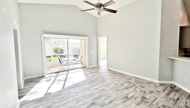 unfurnished living room featuring ceiling fan, high vaulted ceiling, and light hardwood / wood-style flooring