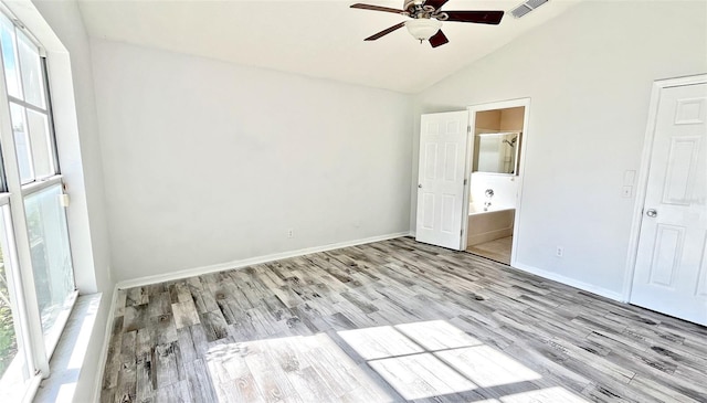 unfurnished bedroom featuring ensuite bathroom, light hardwood / wood-style floors, lofted ceiling, and ceiling fan