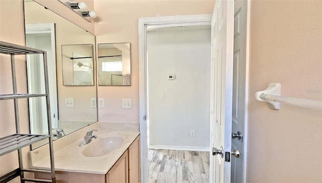 bathroom with vanity and hardwood / wood-style flooring