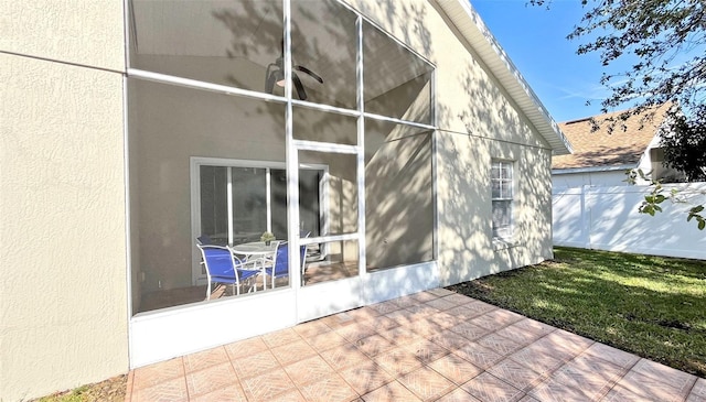 exterior space featuring a sunroom and a patio area