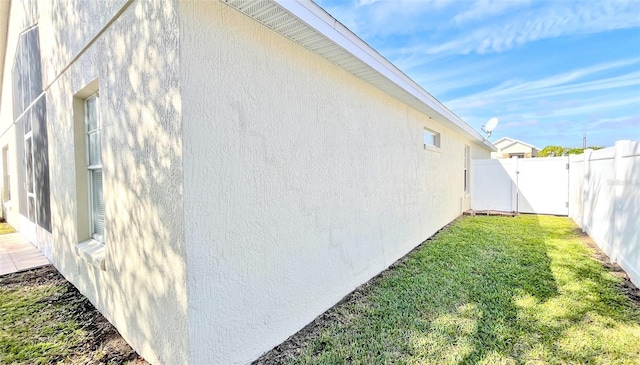 view of home's exterior with a lawn