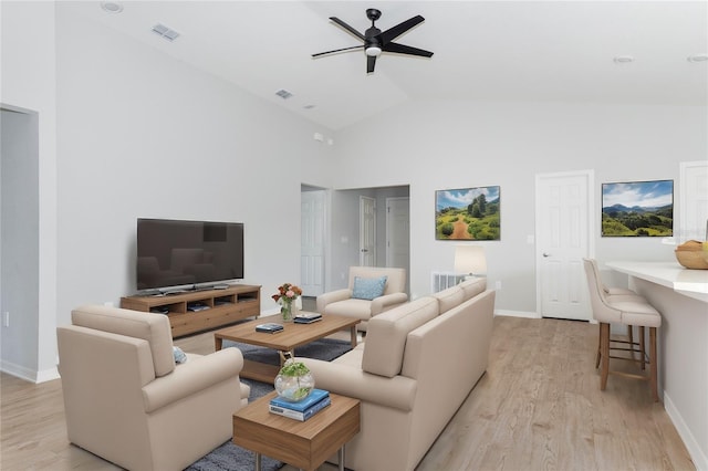 living room with high vaulted ceiling, ceiling fan, and light hardwood / wood-style flooring