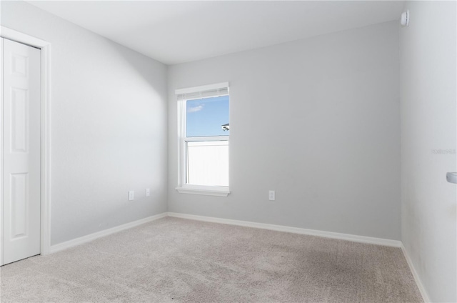 spare room with a healthy amount of sunlight and light colored carpet